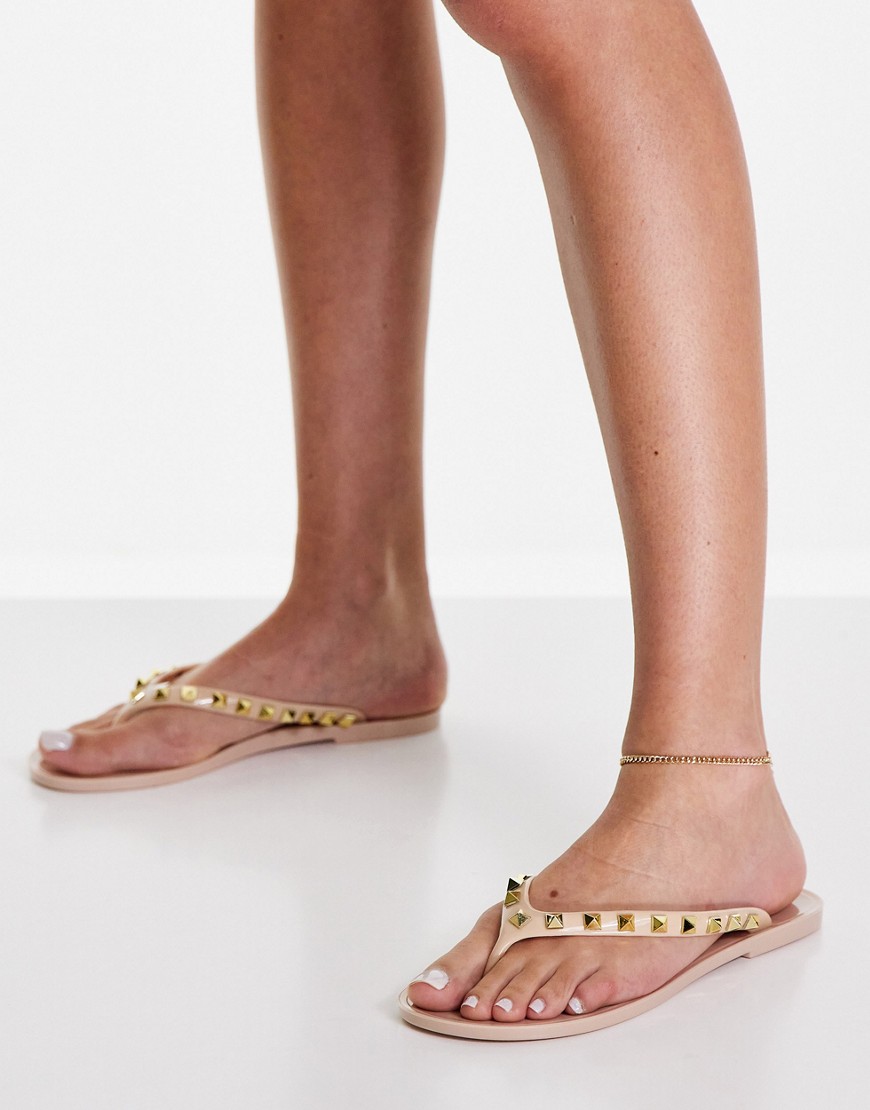 Truffle Collection studded jelly flip flops in beige-Neutral