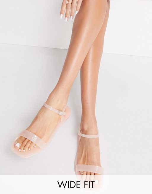 Truffle Collection wide fit flat jelly sandals in beige ASOS