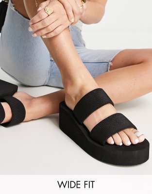 Truffle Collection Wide Fit - Flatform-Mules-Sandalen in Schwarz