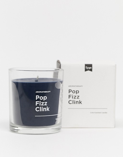 Typo candle in cola scent with slogan pop fizz clink