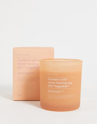 Typo candle jar with 'content' slogan in tangerine and peach scent