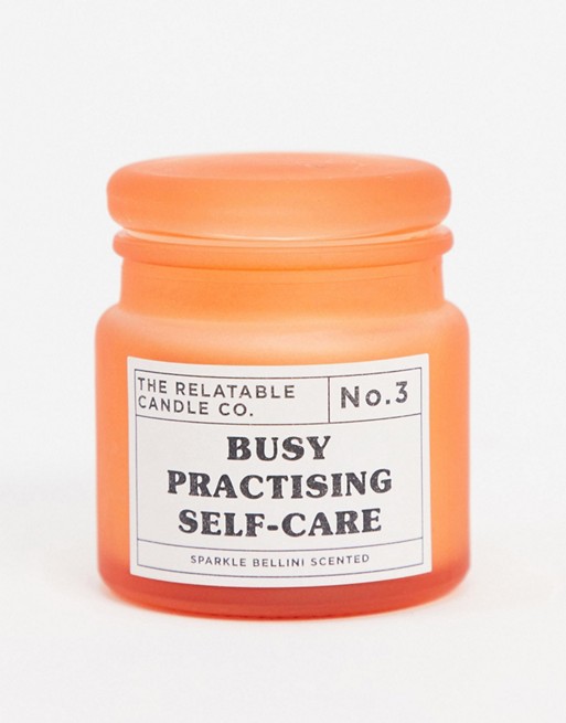 Typo glass candle with self care slogan in coral
