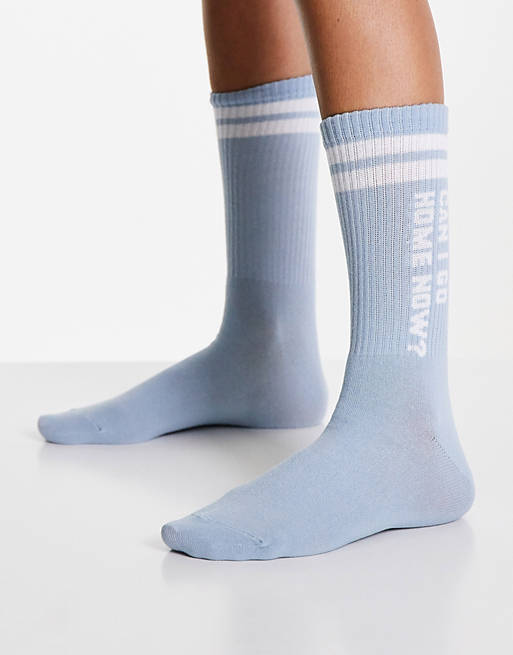Typo socks with 'can I go home' slogan in pale blue
