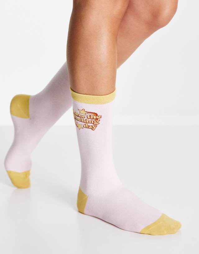 Typo socks with 'seize the day' slogan in pink