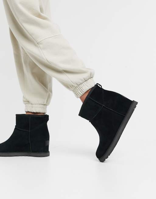 UGG Classic Femme Mini wedge heel boots in black | ASOS