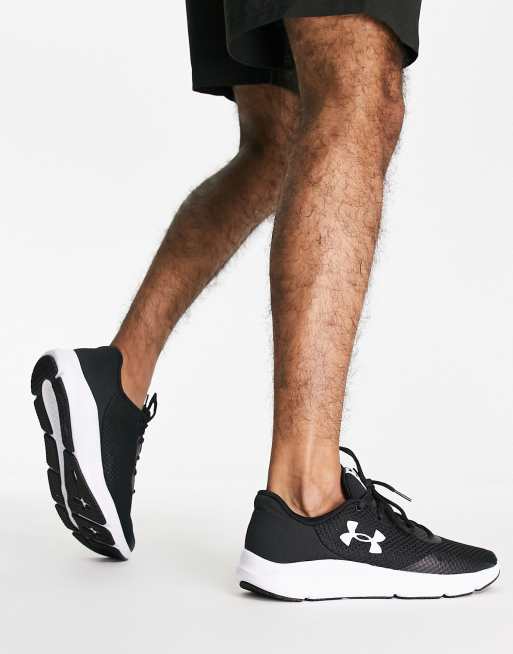 Under Armour Charged Pursuit 3 trainers in black and white