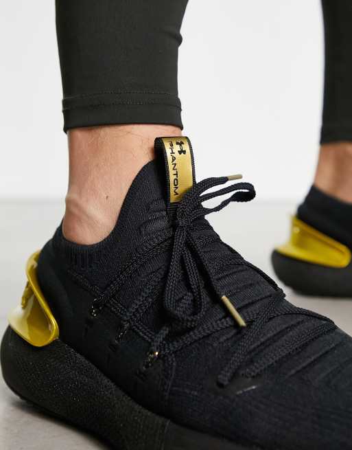 Black and gold store under armour shoes