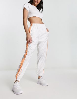 Under Armour Rush Woven Pant in white and orange