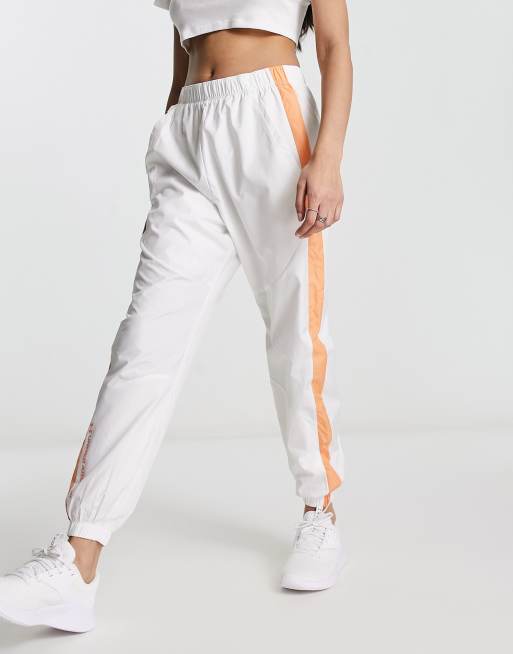 Under Armour Rush Woven pants in white and orange