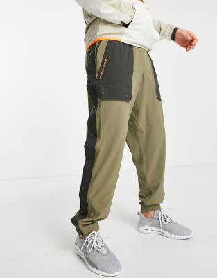 Under Armour Under Armour Training Rush woven trousers with pocket detail in khaki-Green