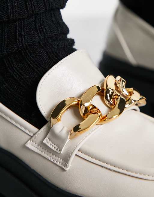 White store gold loafers