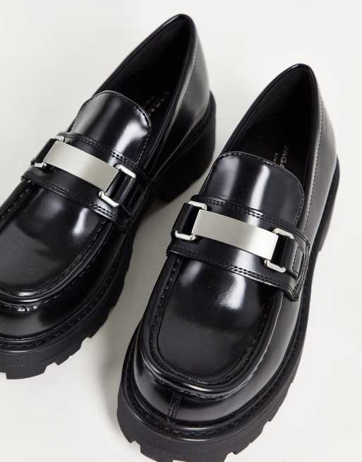 Vagabond chunky black leather loafers with chunky sole and chunky silver buckle detail. 