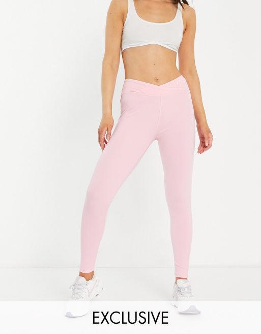 ASOS DESIGN fold over waistband flared leggings in pink (part of a