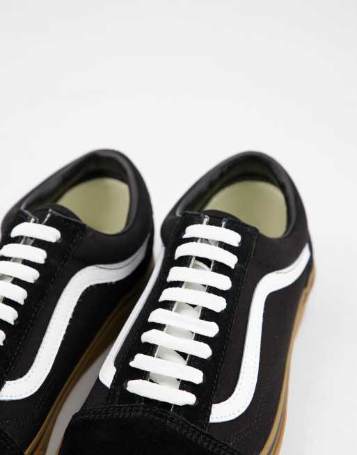 Black and white store vans gum sole