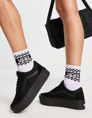 black canvas slip on vans