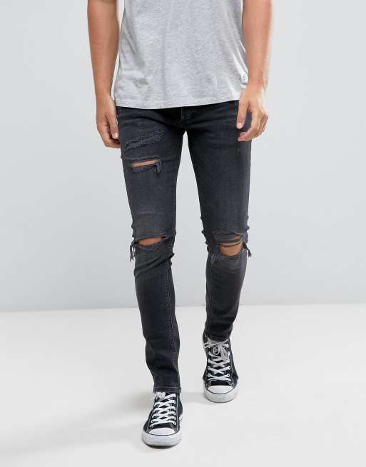 Vaqueros ajustados con rotos en negro lavado de River Island