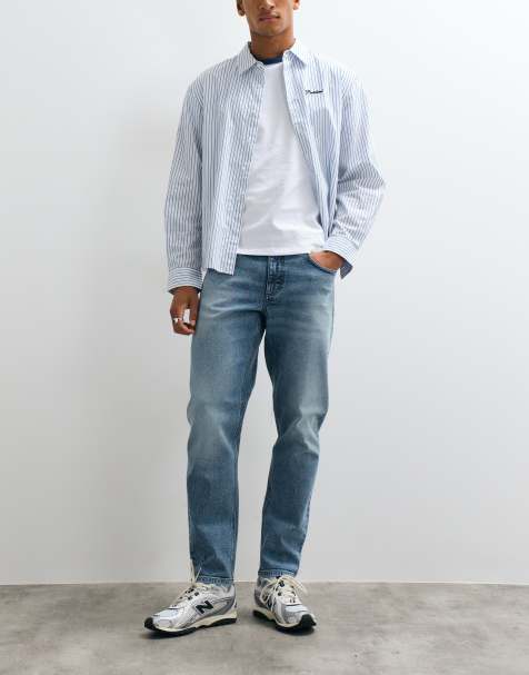 Vaqueros azules de corte tapered con lavado medio tintado de ASOS DESIGN - view 1