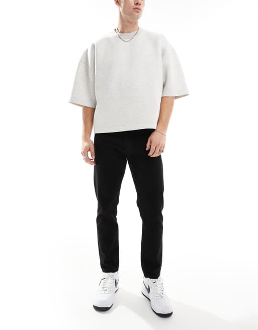 Vaqueros capri negros rígidos de corte tapered de DTT
