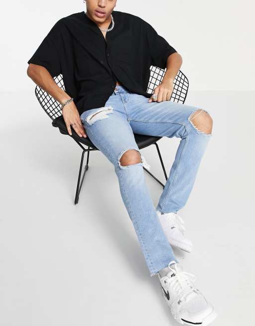 Vaqueros con lavado azul claro, diseño muy rasgado y bajos sin rematar de corte pitillo de ASOS DESIGN