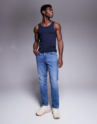 Vaqueros de corte slim con lavado azul medio tintado de ASOS DESIGN - view 1