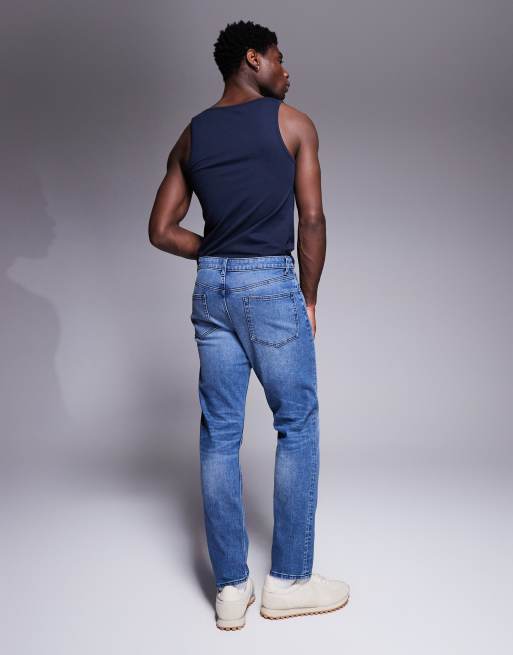 Vaqueros de corte slim con lavado azul medio tintado de ASOS DESIGN, 3 de 5