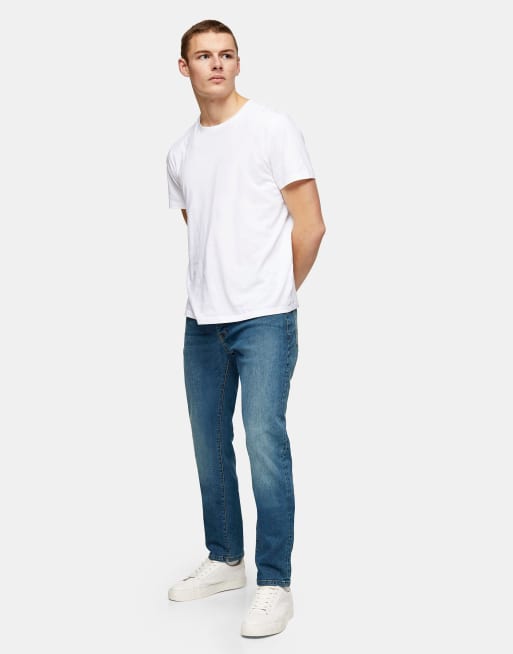 Vaqueros de corte slim elástico con lavado azul medio de Topman