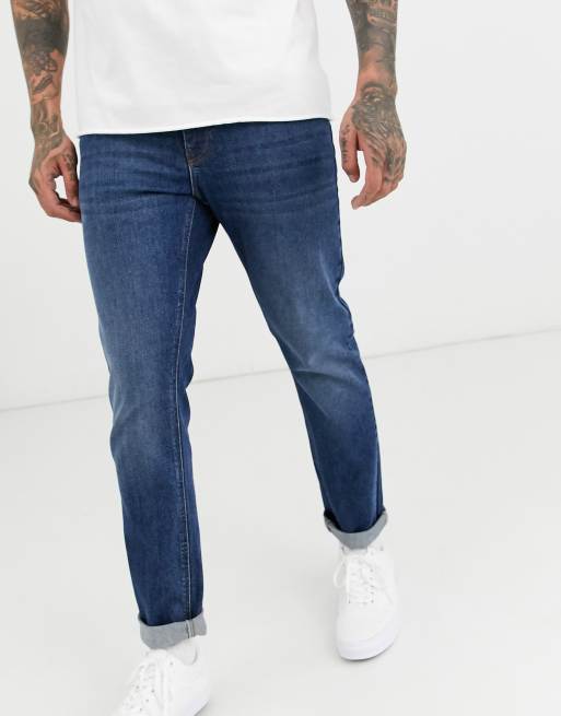 Vaqueros de corte slim elástico con lavado oscuro de ASOS DESIGN