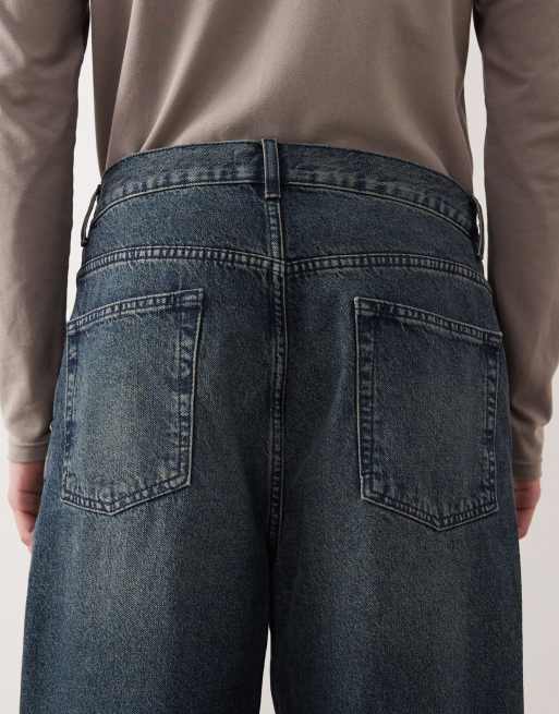 Vaqueros de corte tapered holgado con lavado azul medio de ASOS DESIGN, 4 de 5