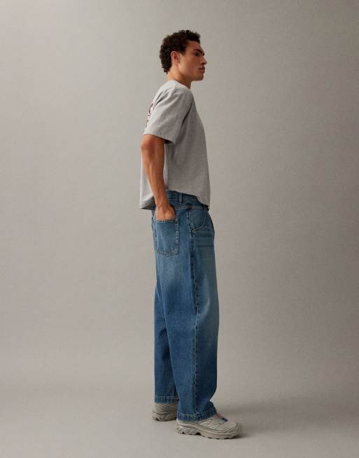 Vaqueros de corte tapered holgado con lavado azul medio y pliegues de ASOS DESIGN, 2 de 7