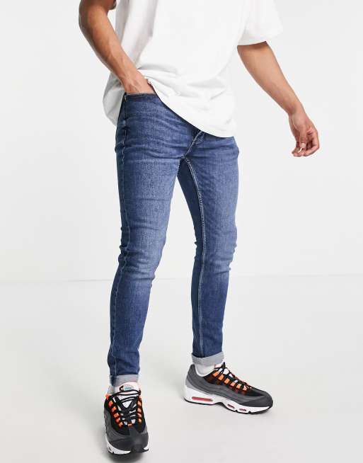 Vaqueros elásticos con lavado azul medio de corte pitillo de Topman