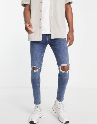 Vaqueros elásticos de corte pitillo con lavado azul oscuro y rodillas rasgadas de ASOS DESIGN