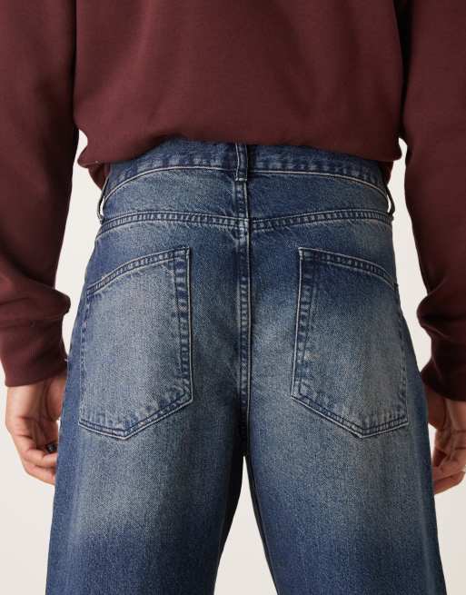 Vaqueros holgados con lavado azul oscuro y abrasiones de ASOS DESIGN, 5 de 5