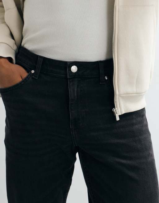 Vaqueros negro desgastado de corte slim elástico de ASOS DESIGN, 2 de 5