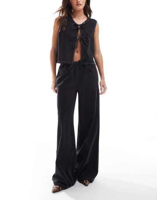 Vaqueros negro lavado de pernera ancha con lazada delantera de ASOS DESIGN