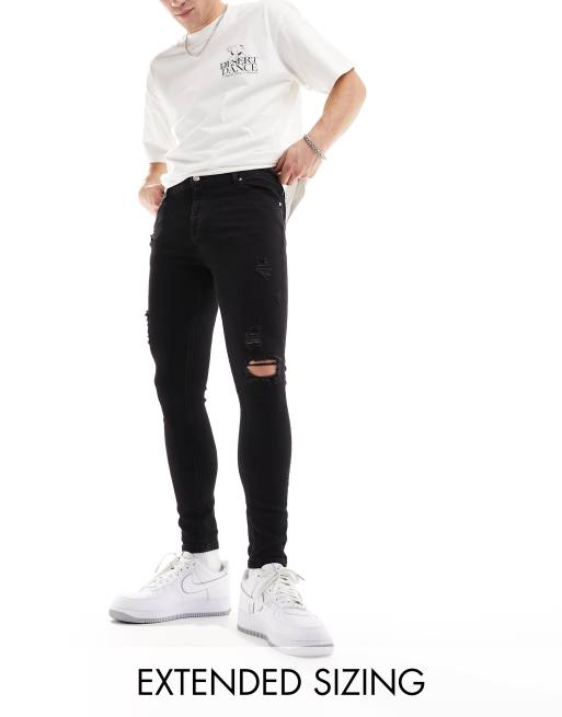 Vaqueros negros de corte superpitillo elástico con diseño rasgado de ASOS DESIGN