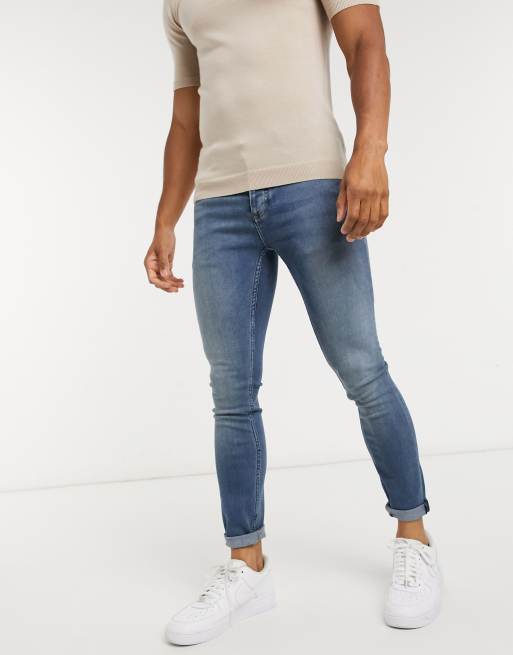 Vaqueros superpitillo con lavado medio azul de Topman