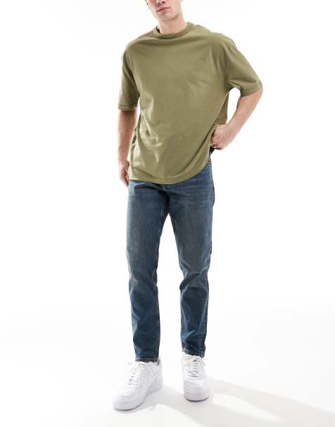 Vaqueros tapered azules con lavado oscuro de corte elástico de ASOS DESIGN - view 1