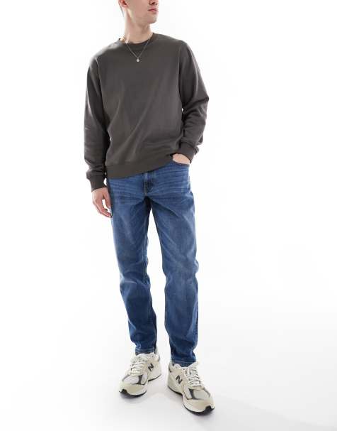 Vaqueros tapered elásticos con lavado medio de ASOS DESIGN - view 1