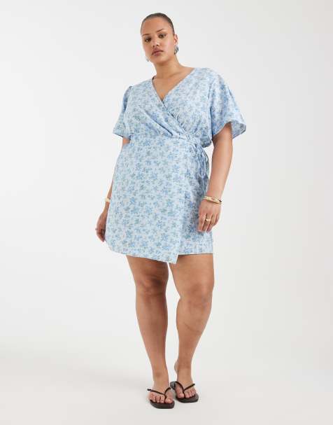 Vero Moda Curve flutter sleeve wrap front mini dress in blue floral print