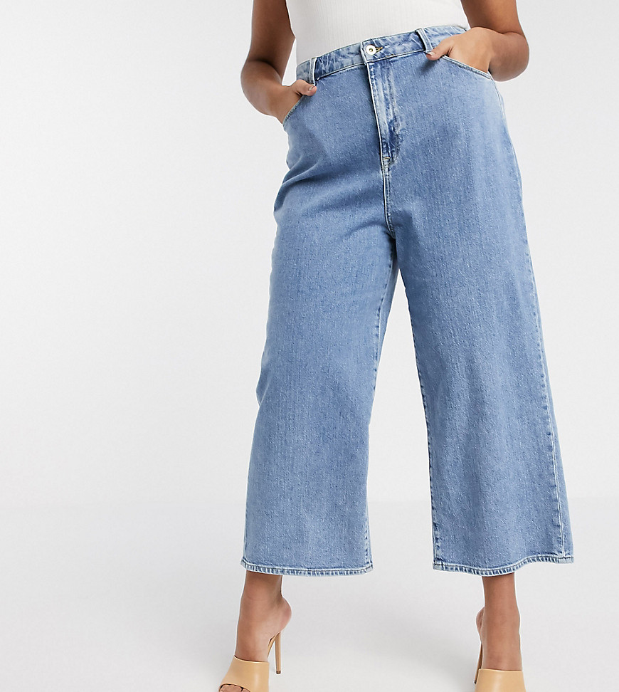 Vero Moda Curve – Mellanblå ankellånga jeans med vida ben