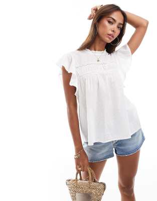 high neck flutter sleeved embroidered top in white-Black