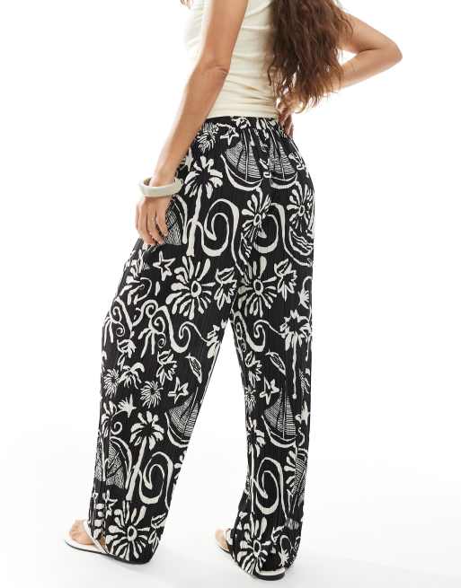 Vero Moda Petite high rise wide leg plisse pants in tropical conversational print
