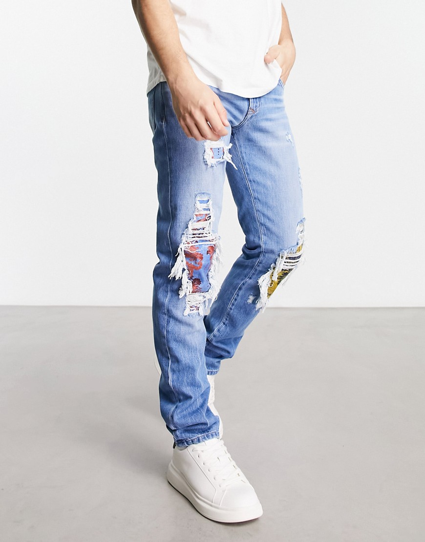 versace jeans couture ripped patch jeans in blue