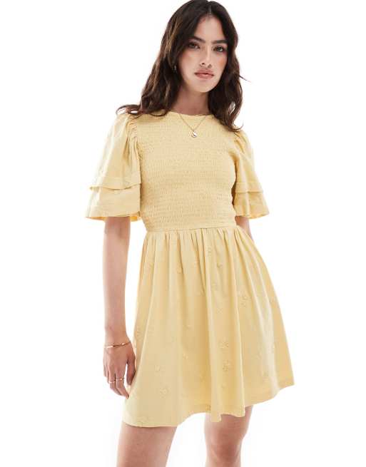 Vestido corto amarillo pastel con mangas abullonadas y diseño bordado de ASOS DESIGN