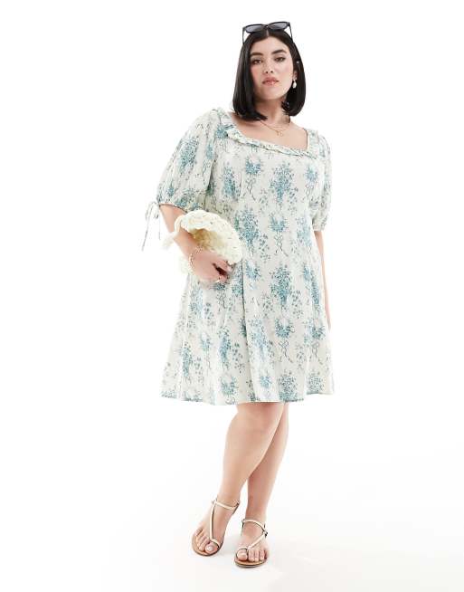 Vestido corto azul con estampado floral, mangas abullonadas y volante en el cuello de ASOS DESIGN Curve
