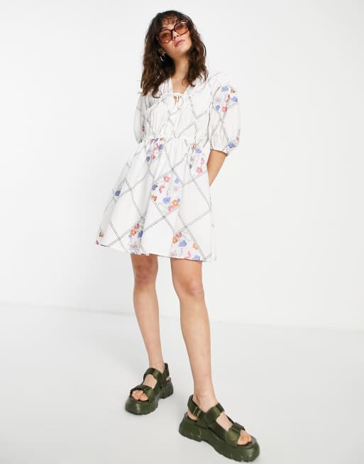 Vestido corto blanco amplio con lazada en la parte delantera, diseño patchwork y bordados florales de ASOS DESIGN