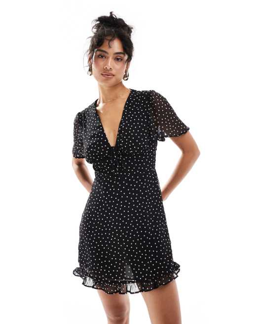 Vestido de tarde negro con estampado de lunares de Mango