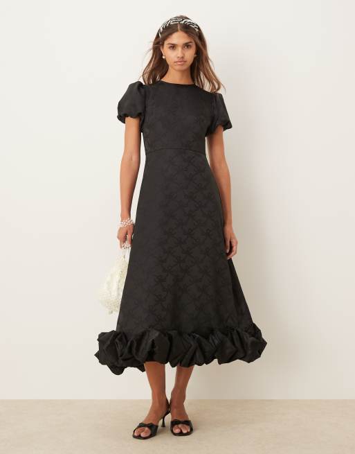 Vestido largo negro con bajo abombado y mangas abullonadas de Sister Jane