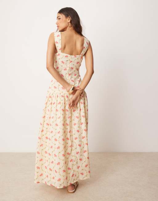 Vestido midi con cintura baja, estampado floral y detalle cruzado