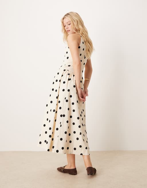 Vestido midi con cuello alto, cintura baja y estampado de lunares